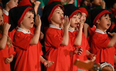 Junior School students dressed in Christmas costumes and singing 