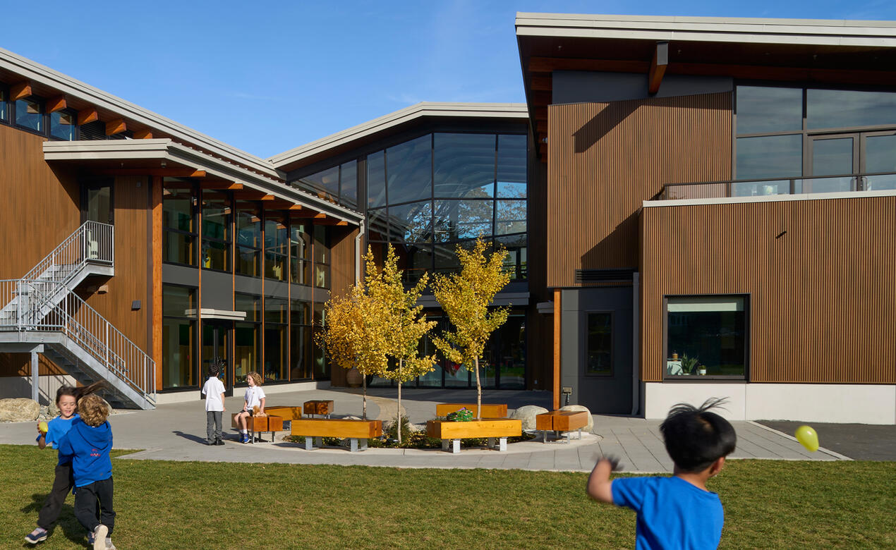 Students play in front of the completed Junior School Annex