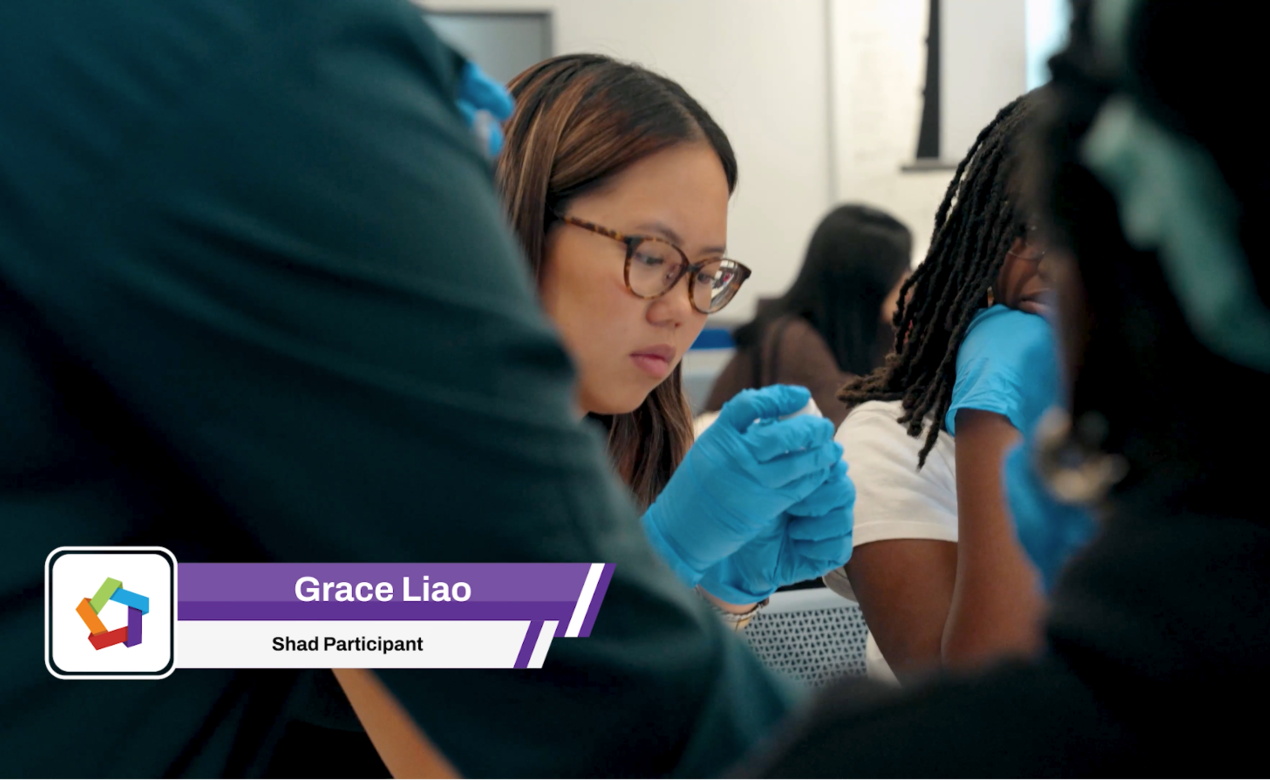 Grace Liao wearing blue latex gloves looking at something in her hands