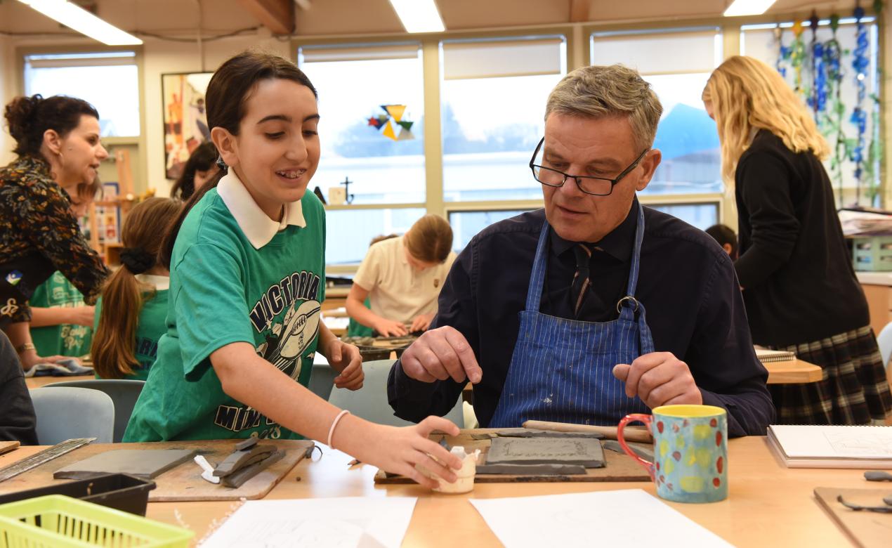 Mark Turner works with a Junior School student to create art