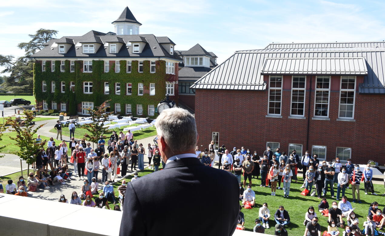 Head of School Mark Turner gives a speech from the Sun Centre balcony