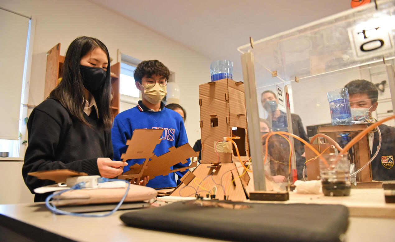 Senior School students demonstrate their cardboard plant watering system built in their ADST course