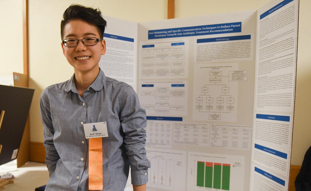 A Senior School student poses with their presentation and ribbon during the Vancouver Island Regional Science Fair.