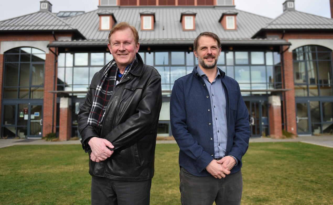Stephen Green with the Victoria Conservatory of Music and Craig Kelley from SMUS pose in front of the music building.