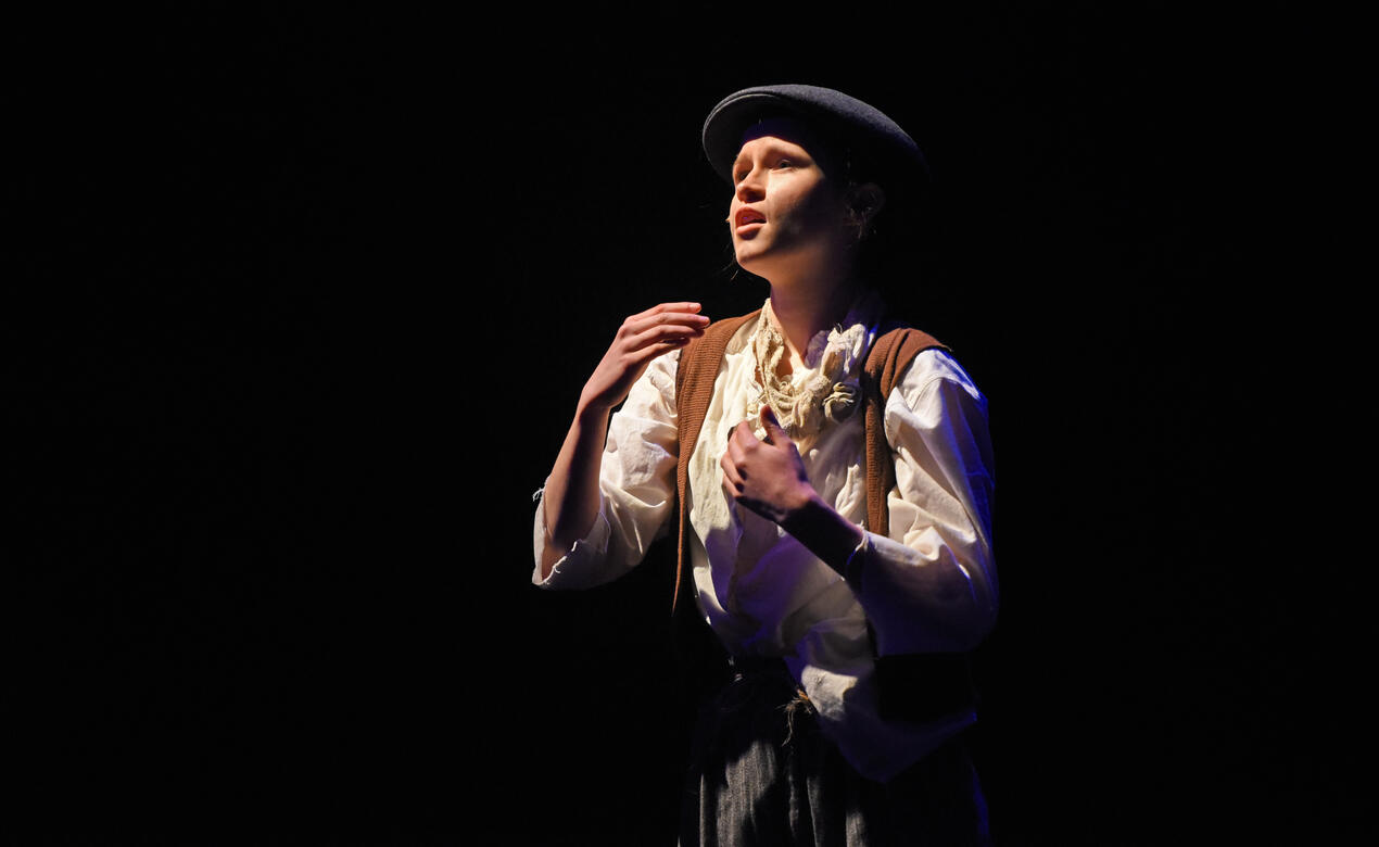 A Senior School student performs a song from the musical Oliver during the 2022 musical, SMUS Revue '22.
