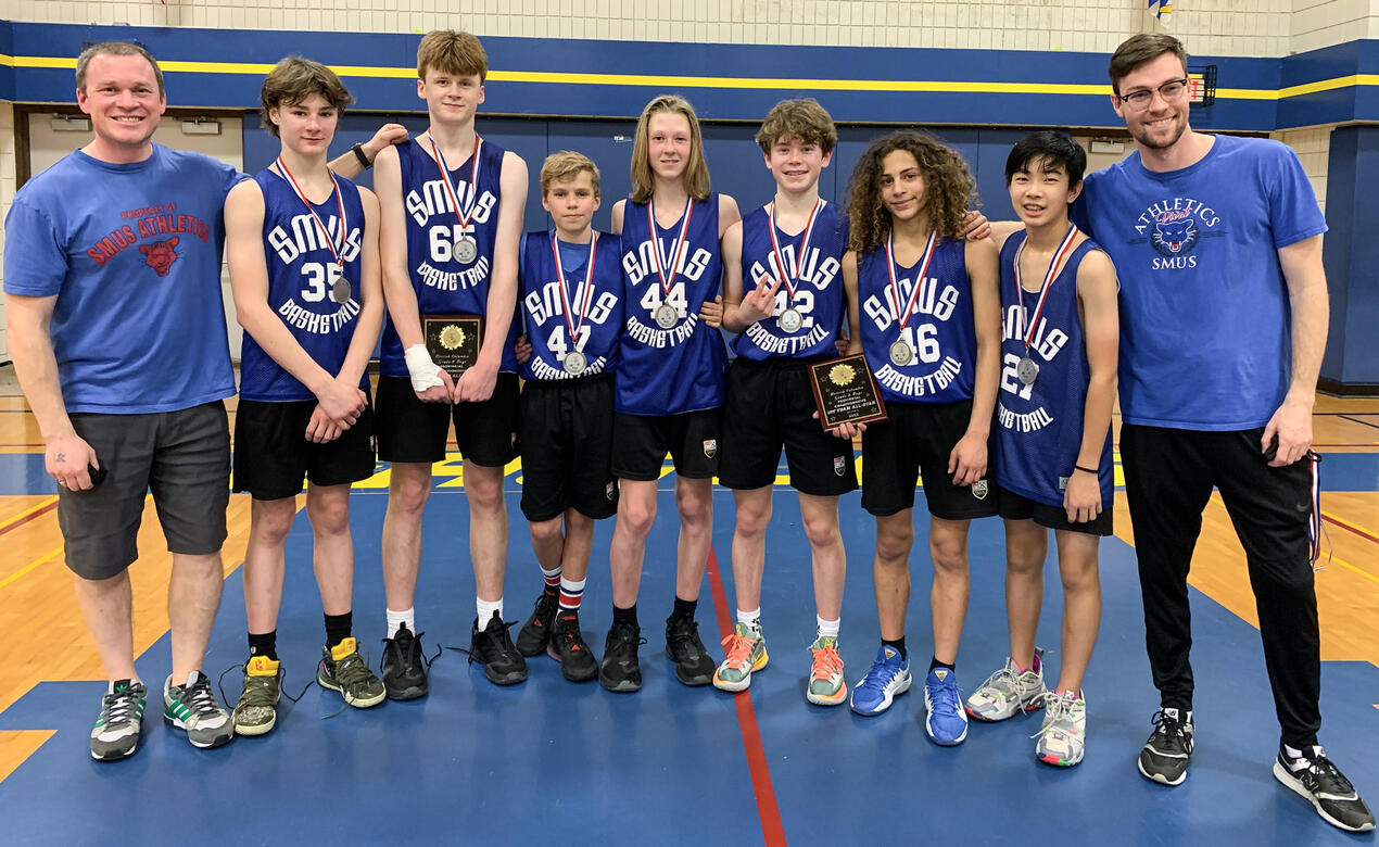 The Grade 8 Boys Basketball team poses with their silver provincial medals