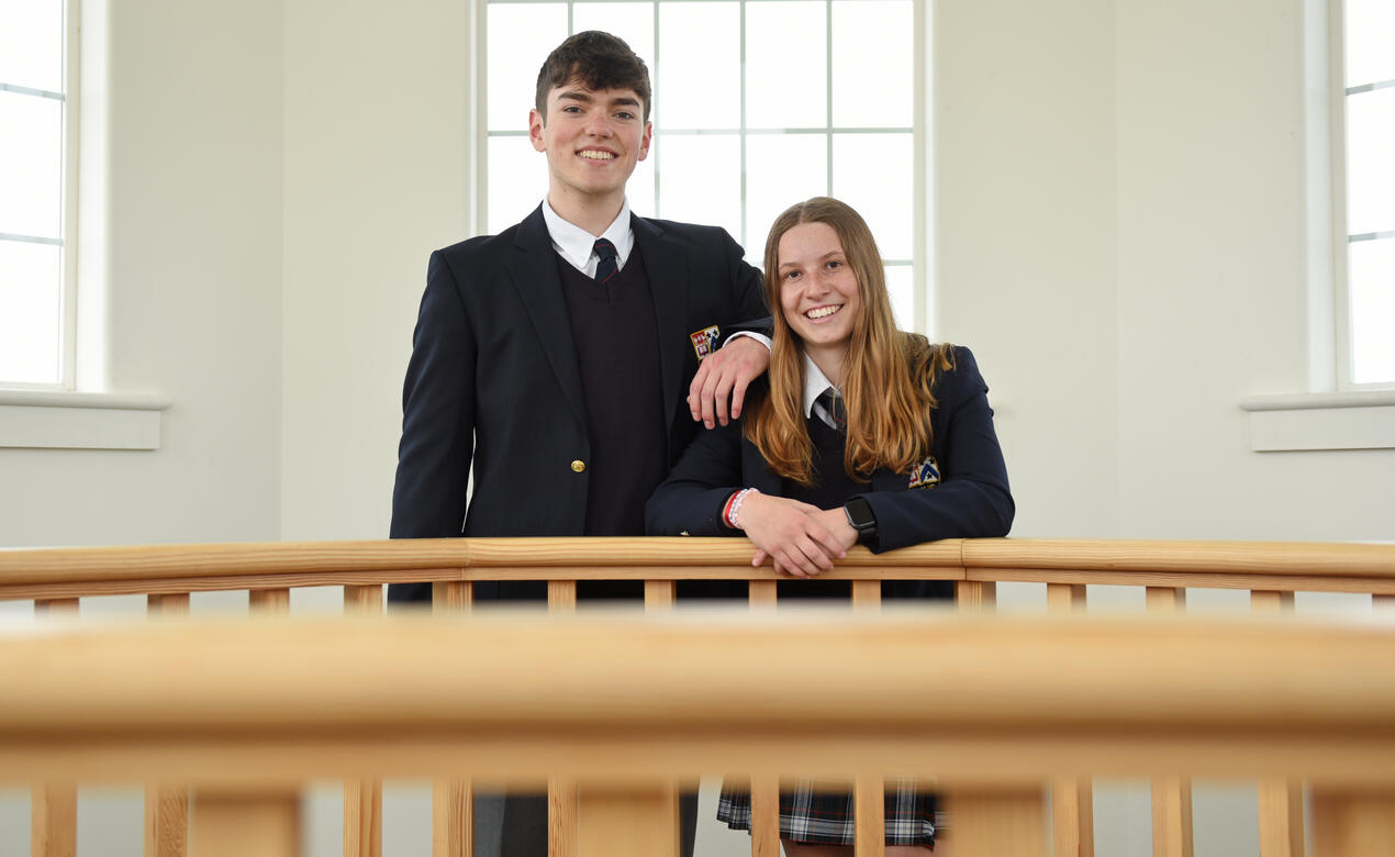 Two Senior School students pose in the School House bell tower