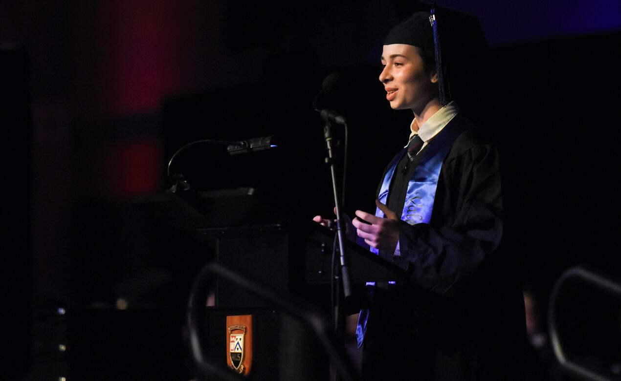 Grade 12 valedictorian Alana Norie stands on stage during graduation and delivers their speech.