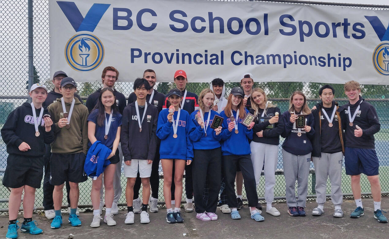 The Senior School Tennis team poses with their medals in front of a BC School Sports Provincial Championship banner