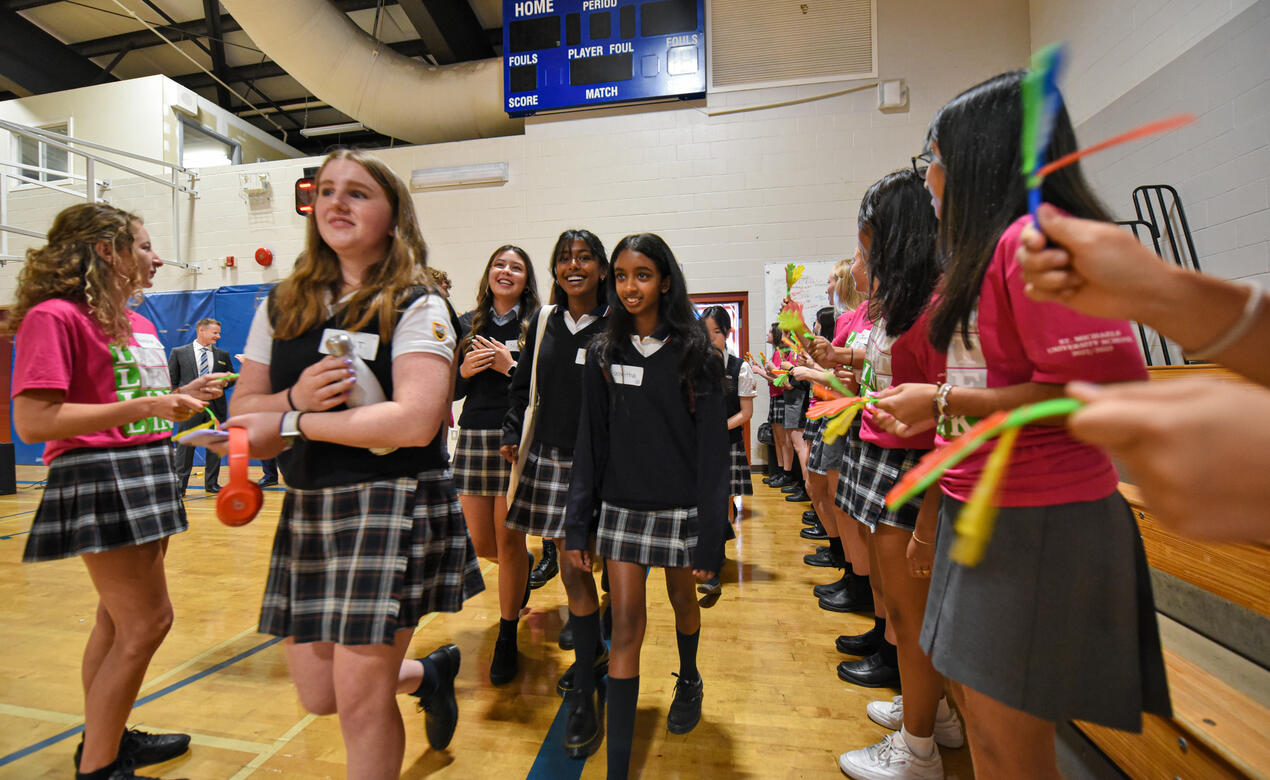 New Senior School students walk through a line of Grade 12 Link Leaders