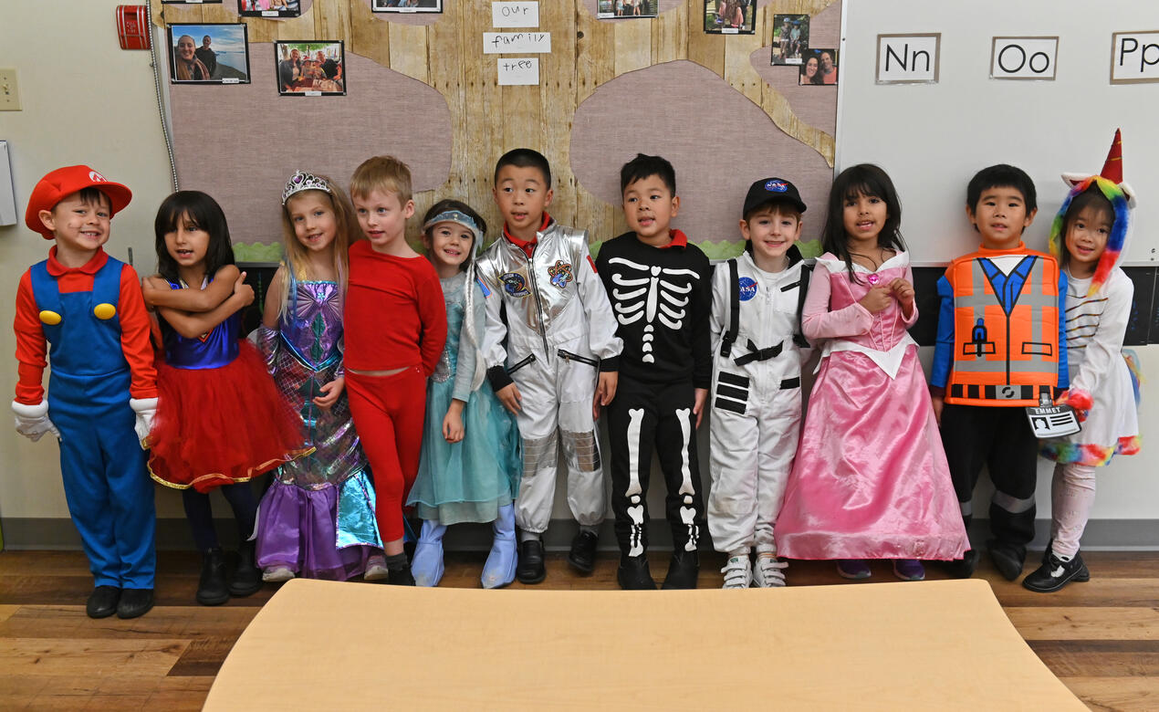 A group of Kindergarten students pose in their Halloween costumes