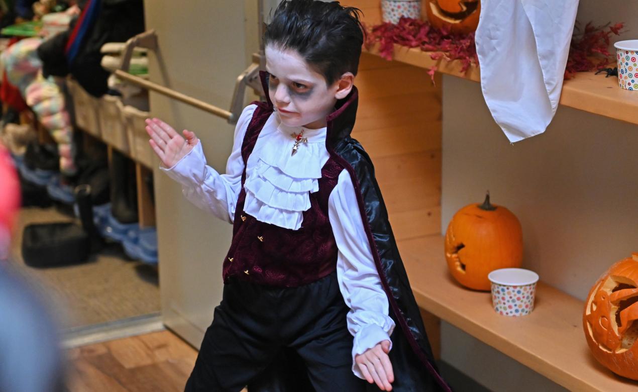 A Grade 1 student dressed as a vampire dances in the Junior School foyer