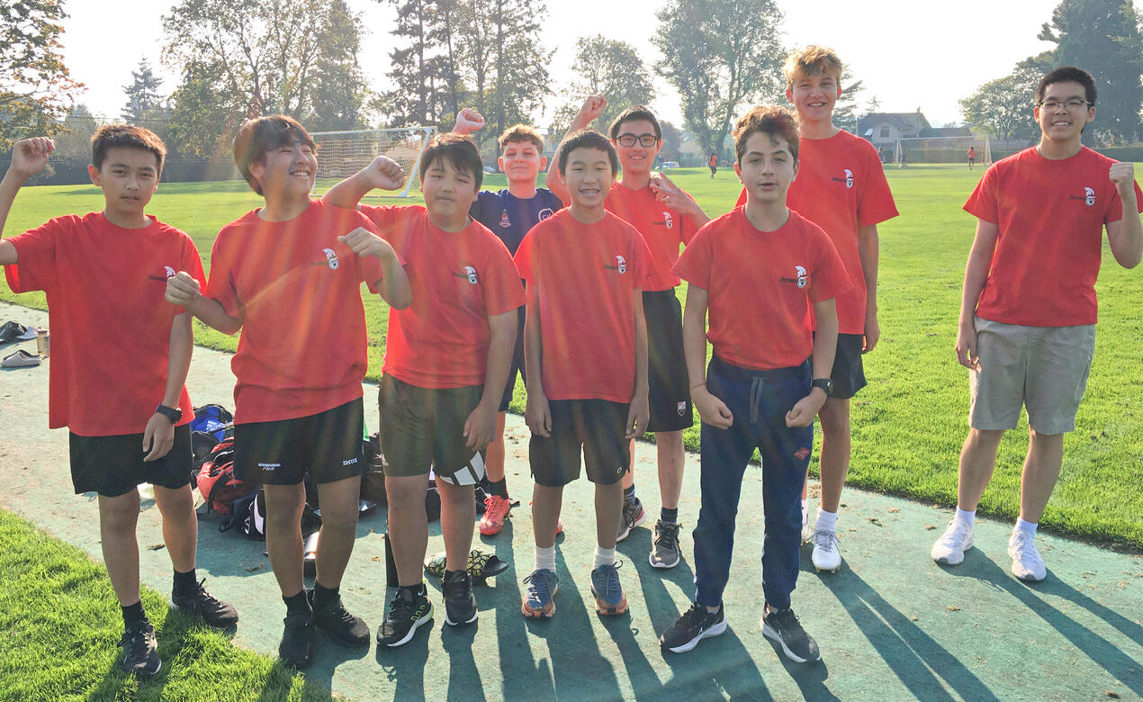 A group of Grade 8 boarding students pose together in their red Barnacle House shirts during House Games.