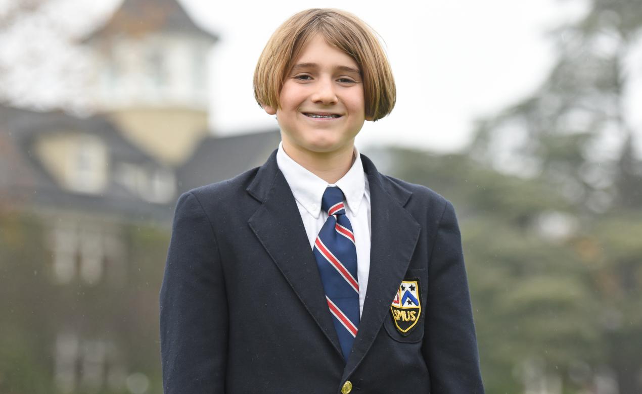 A photo of Middle School student Andrei Marti in front of School House