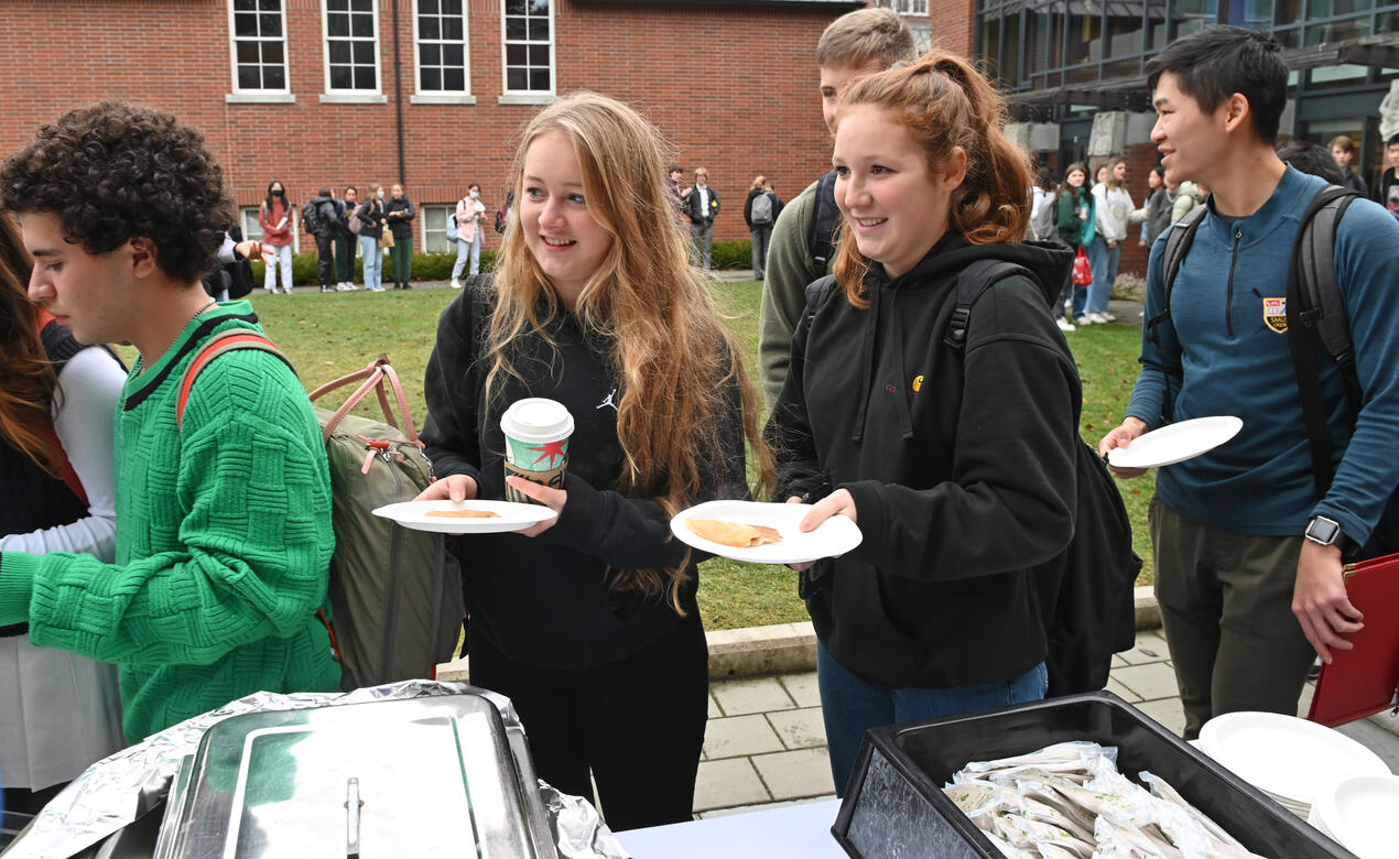 A pair of Senior School students carry plates of pancakes during the annual Shergold Pancake Breakfast
