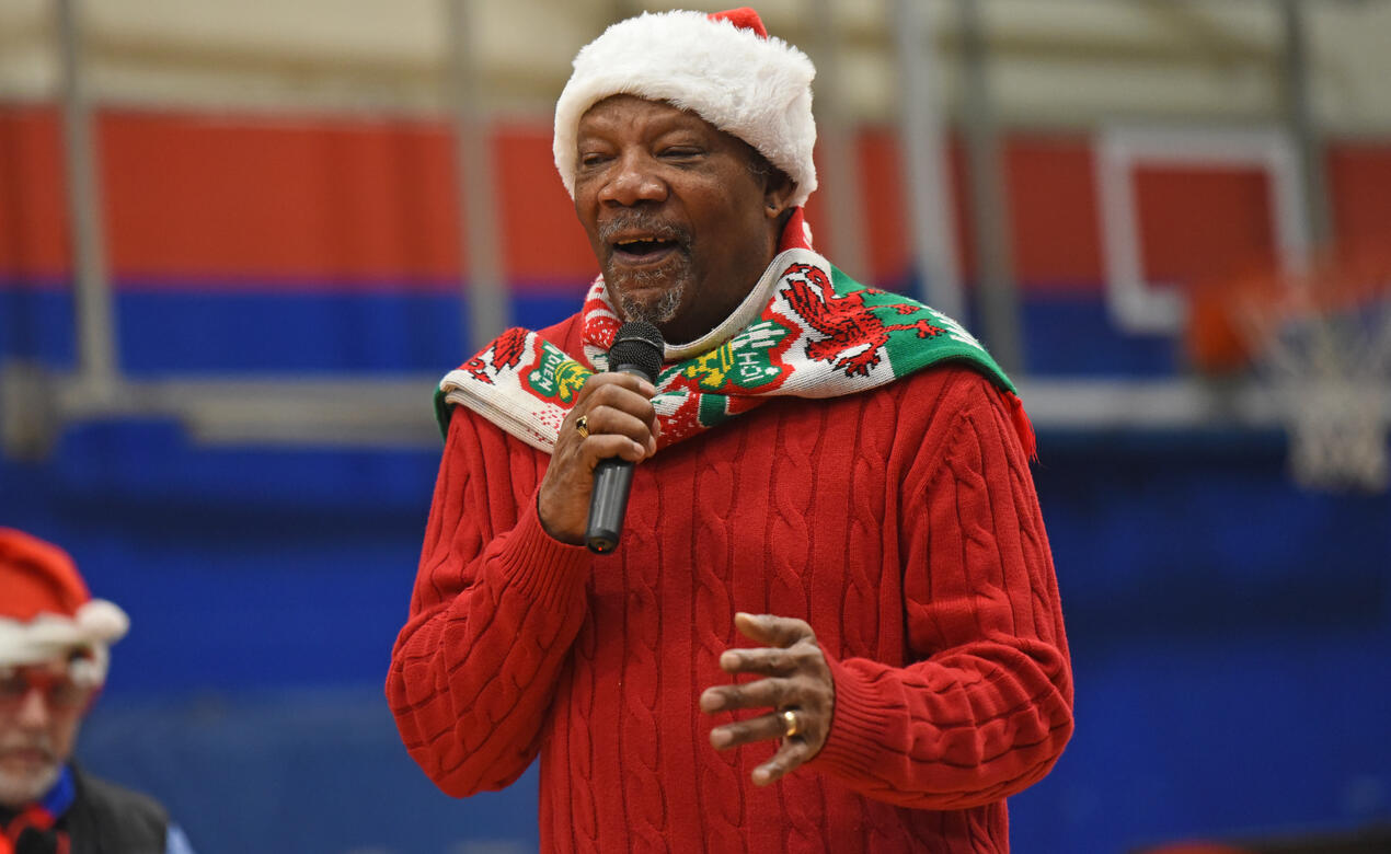 A photo of Tony Cordle dressed in Christmas clothing while performing "The Christmas Song"