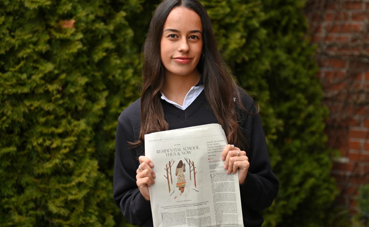 Grade 12 student Naashkii Soler poses with a copy of an article she had published in The Globe and Mail