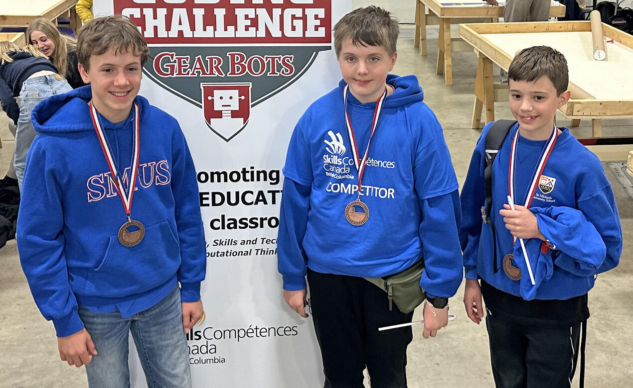 Members of the Grade 7 Robotics team post with their bronze medals after reaching the podium at provincials.