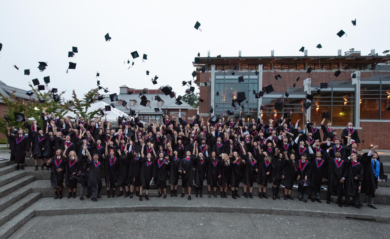 2023 Grads toss their hats in the air