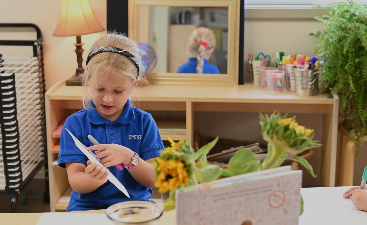 A student discusses her drawing