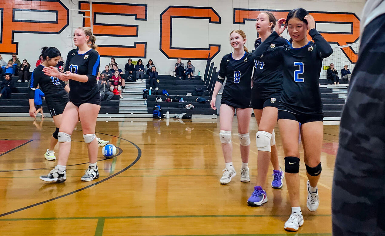 The Junior Girls Volleyball team take a break between sets