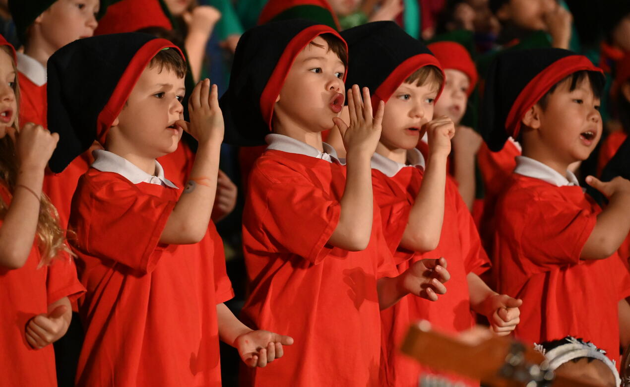 Junior School students dressed in Christmas costumes and singing 