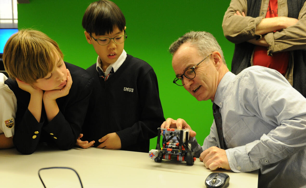 A photo of Peter Steed with Middle School students