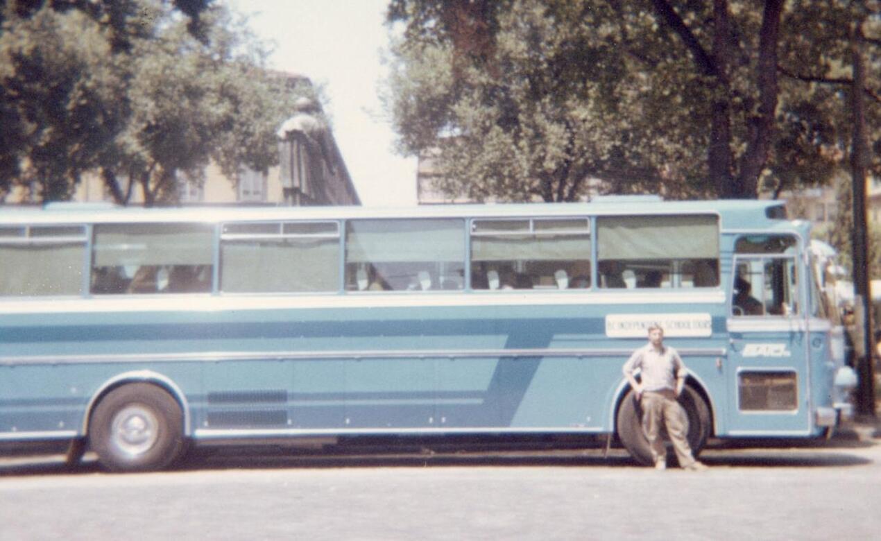 Driver Leo de Vrieze stands next to the tour bus in 1969
