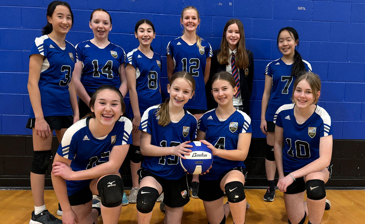 Students smile and laugh after winning the City volleyball championship