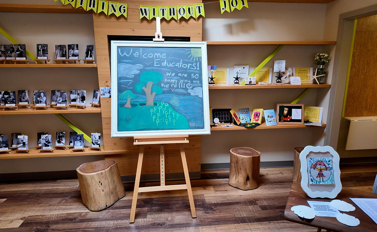 The lobby of the Junior School shows a chalkboard sign welcoming educators for a conference.