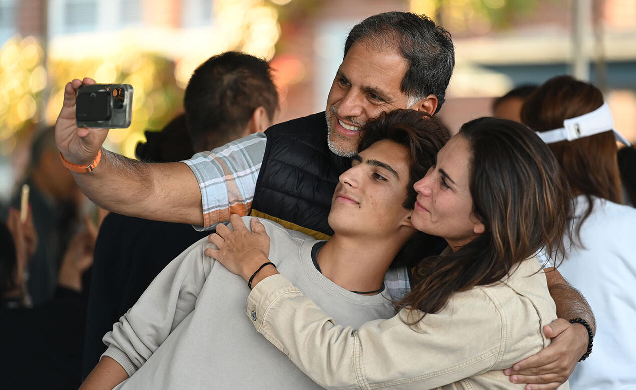 A family takes a selfie just before parting for the new school year