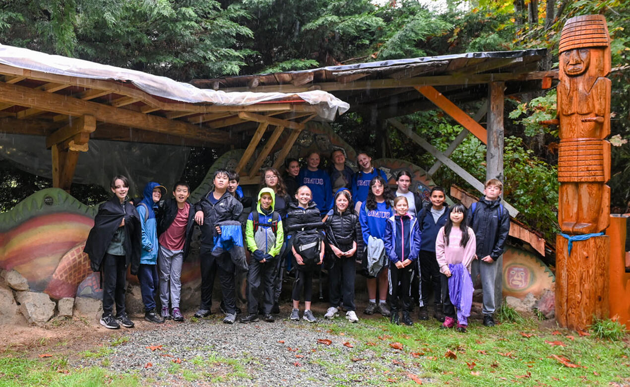 SMUS Middle School grade 7 class poses at EcoVillage