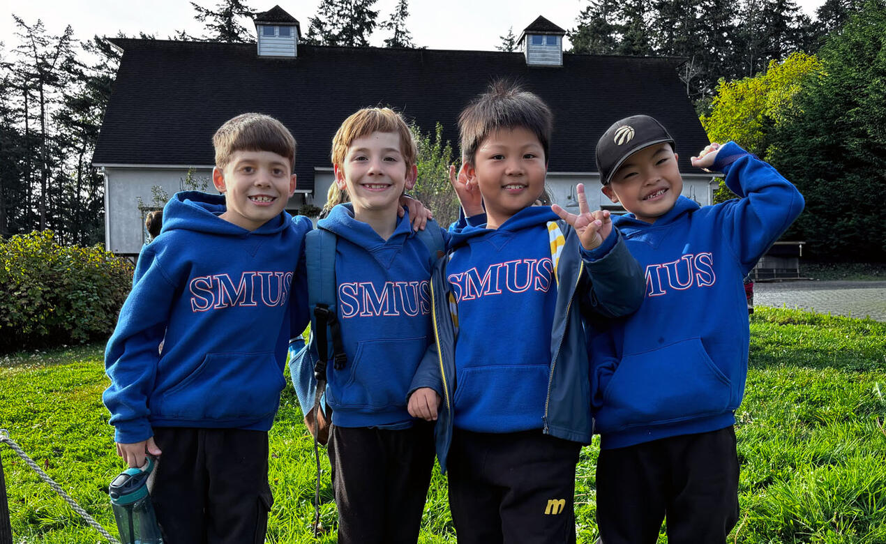 Four Grade 2 students pose for a photo at Sea Cider Farm