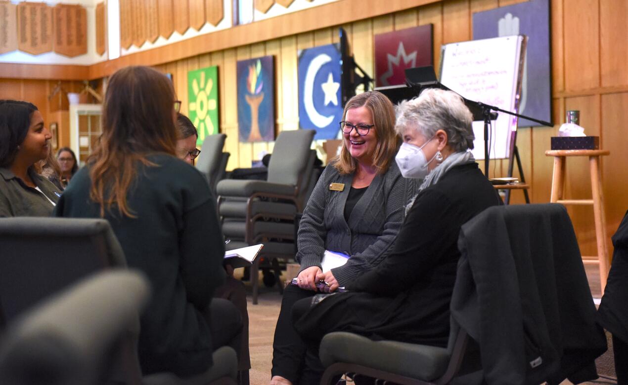 Carle McMillan smiles as she listens in on a group conversation 