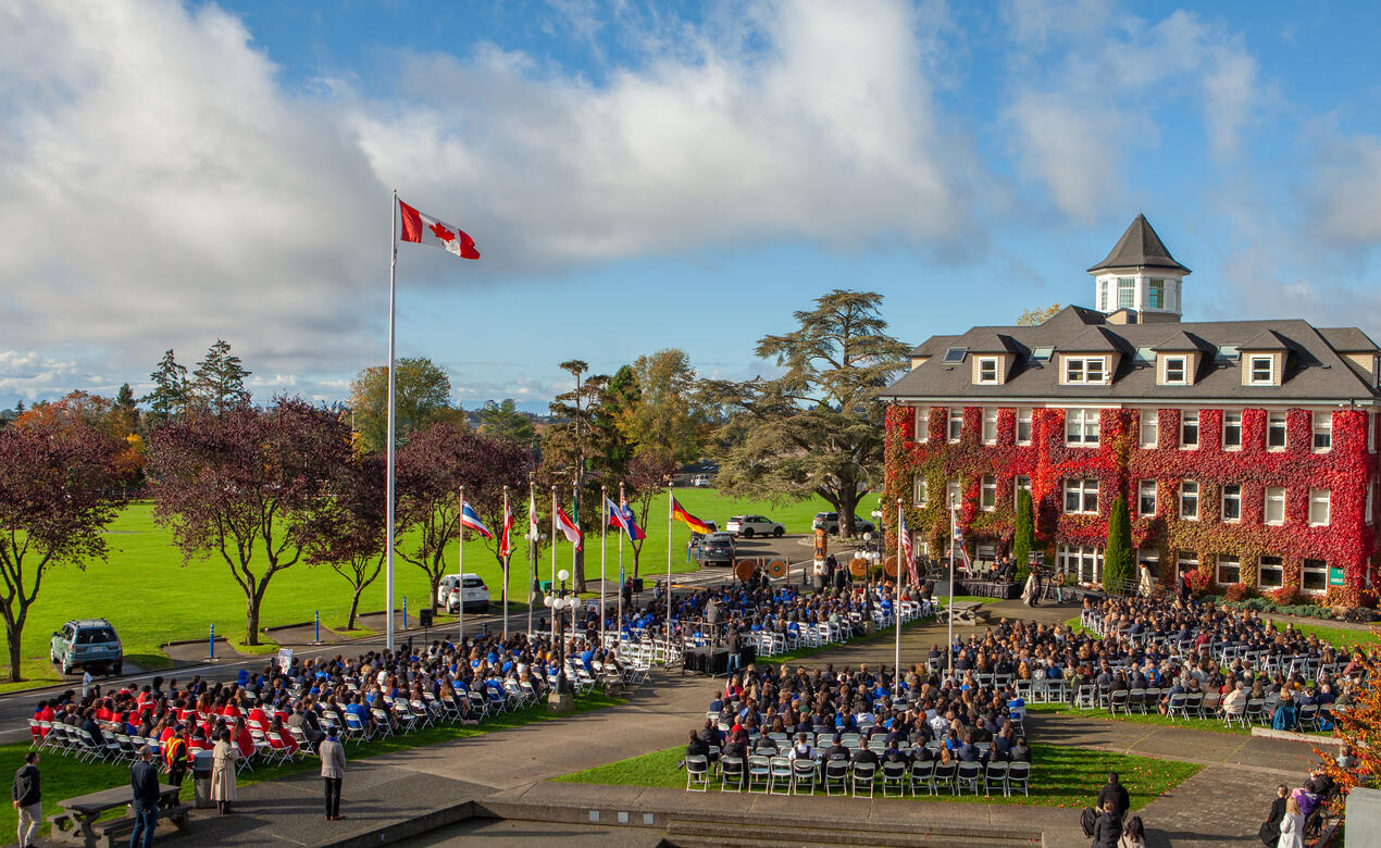 Over 1,000 staff and students gather in the quad for the Welcome Pole ceremony with blue skies