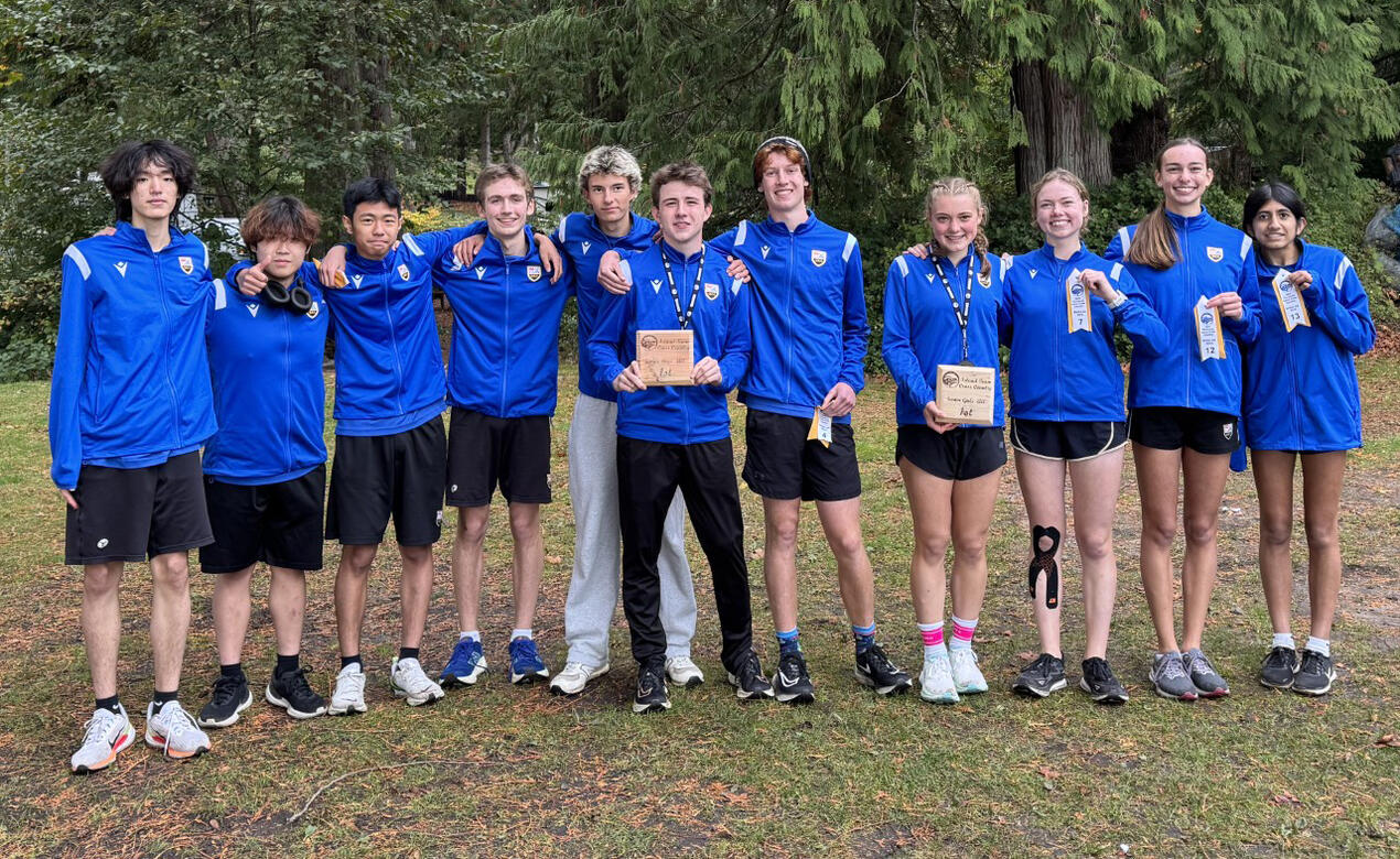 The Cross Country team holding their trophies from the Island Championship