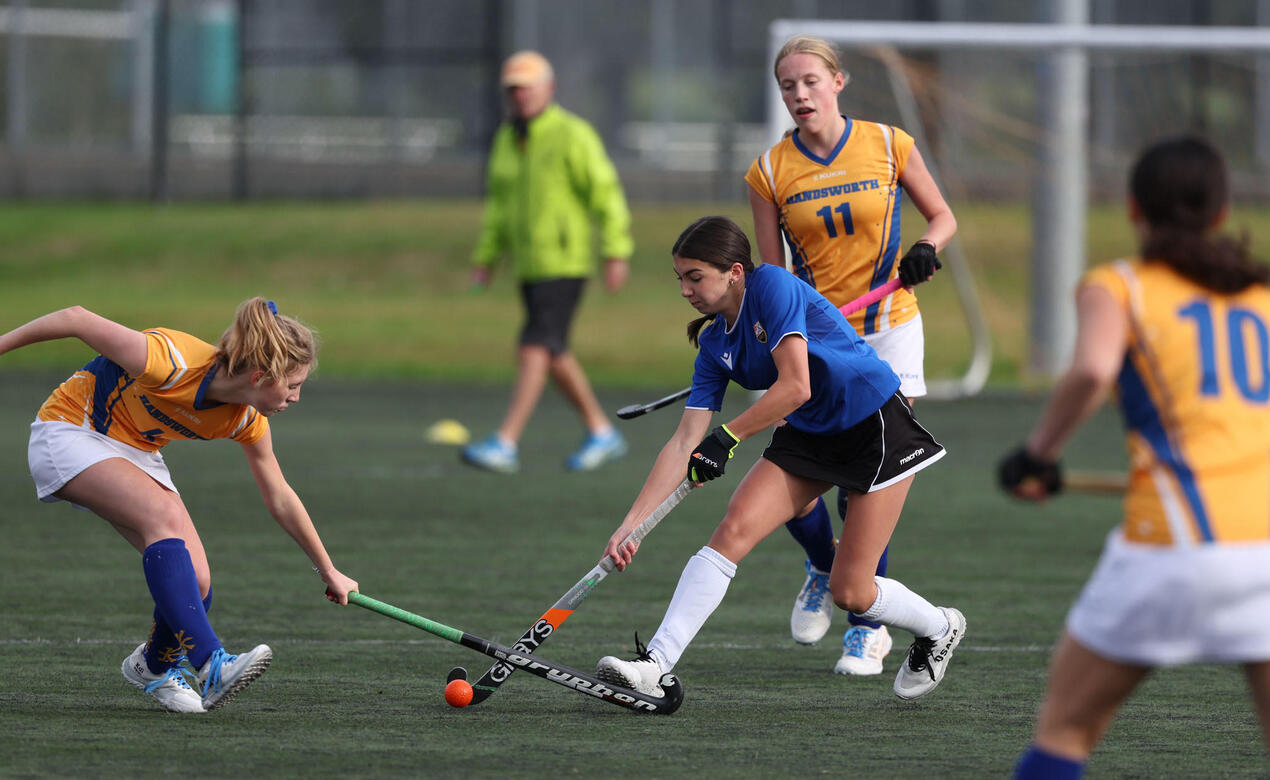 A SMUS player dribbles the ball through defence