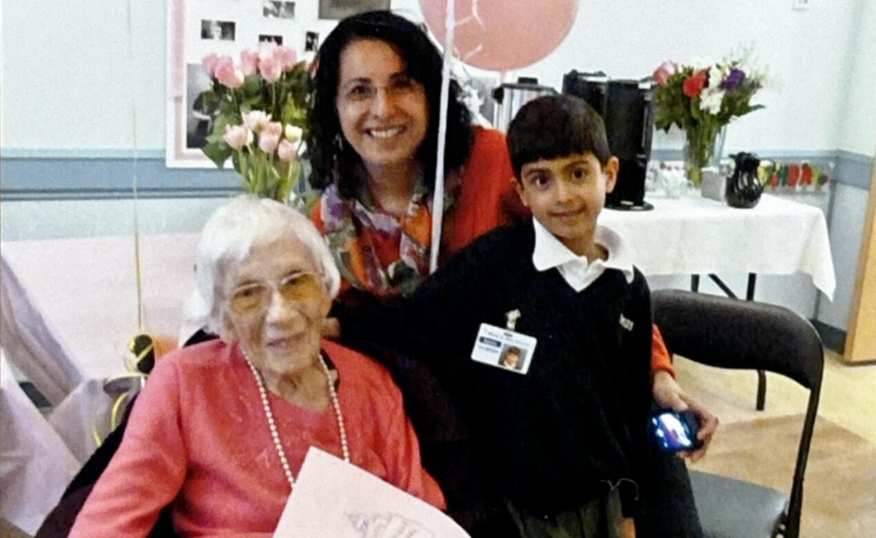 A young SMUS student Aaron Gill and his mom pose for a picture while volunteering