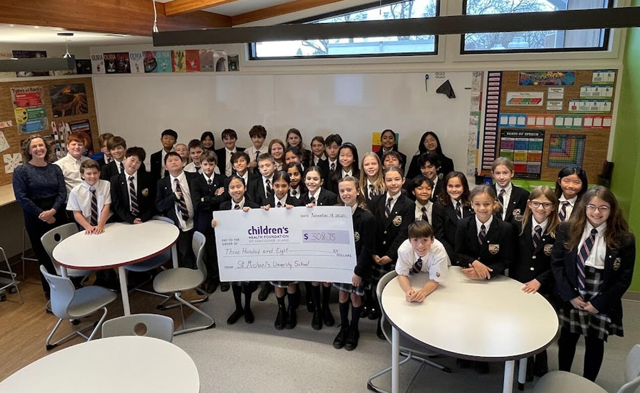 Grade 5 students with the cheque they presented to Jeneece Place