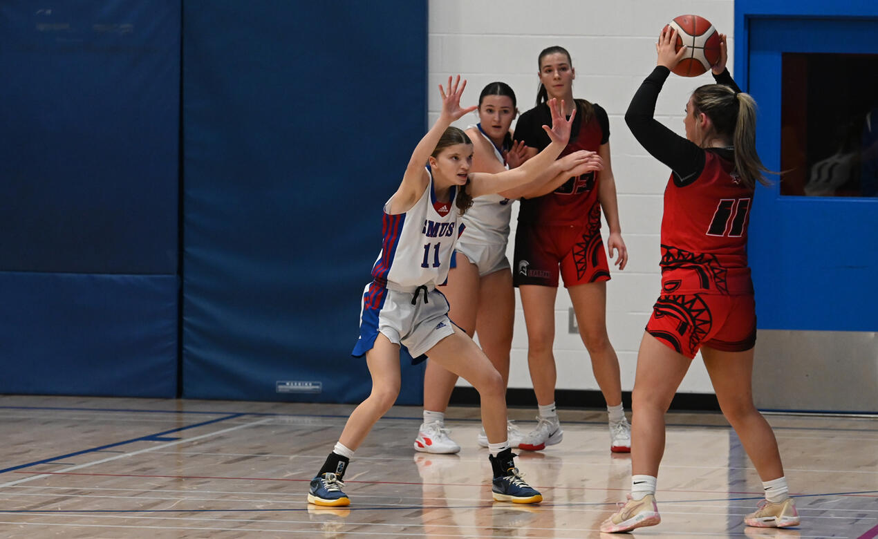 SMUS players block the opposition players just outside the three-point line