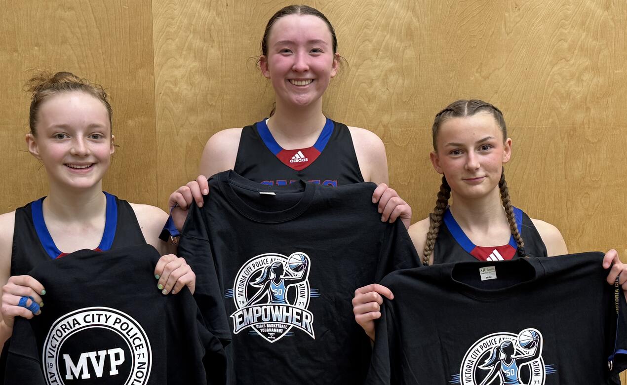 Three Junior Girls basketball players pose with their t-shirt awards