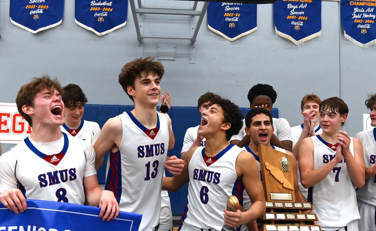 Senior Boys Basketball players celebrate together