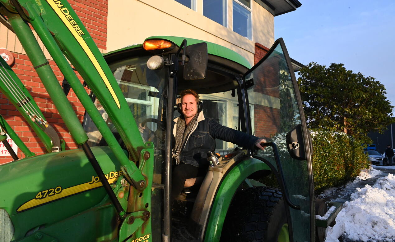 Grounds worker Colin Craveiro opens the door of his tractor used to clear snow