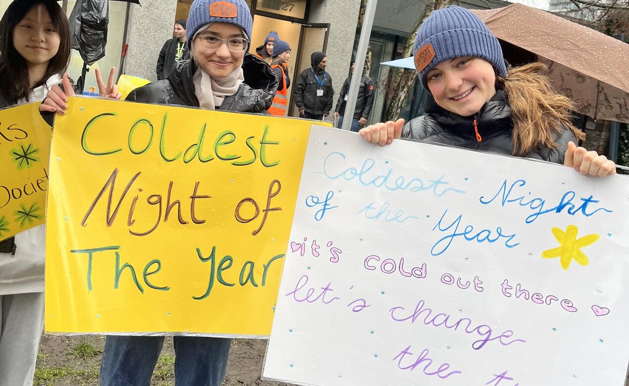 SMUS Students hold up their signs for Coldest Night of the year ahead of the 5-km walk