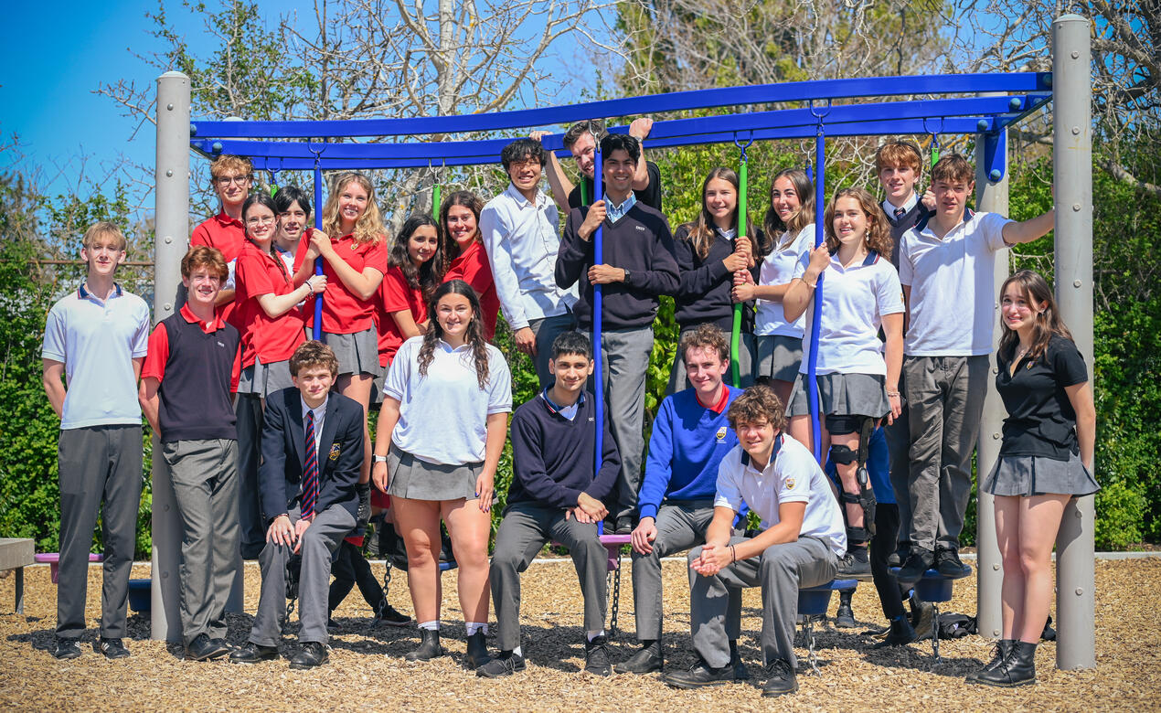 The Lifers Class of 2025 returns to the Junior School for a group photo on the playground.
