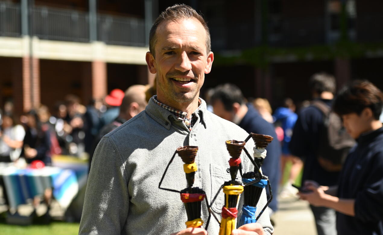 Regan Daly poses with handmade dolls for sale in support of Hope for Youth Uganda