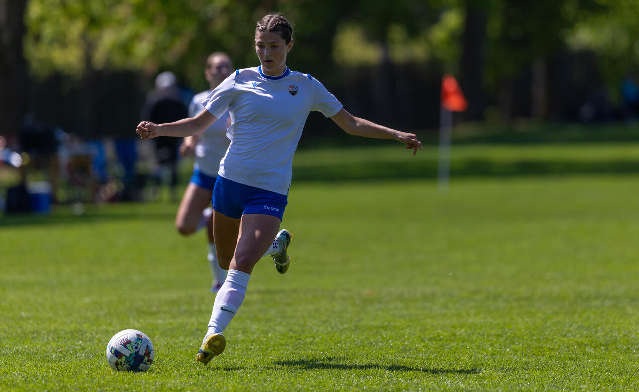 Senior Girls Soccer player Olivia Pickering kicks the ball