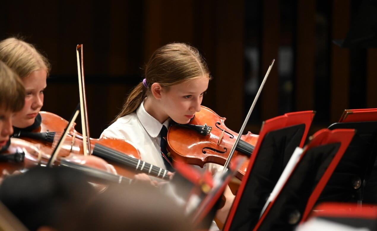 Middle School Strings Violinist performs during concert