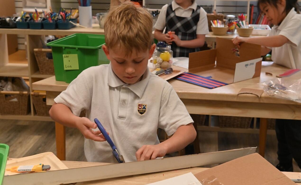 Grade 2 student uses scissors and cardboard in the iLab