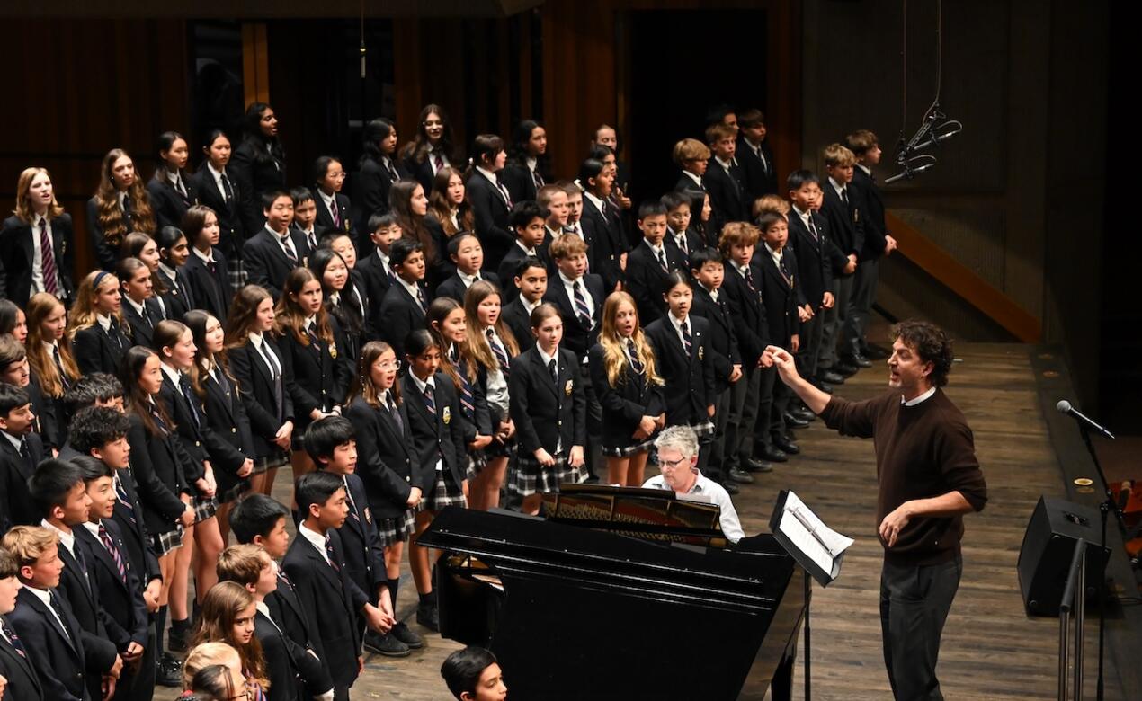 Middle School Choir takes to the stage with Duncan Frater conducting. 